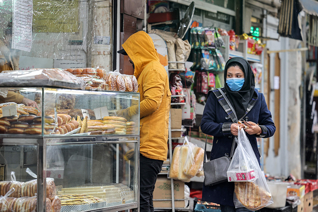 TEHRAN: A woman walks past a bakery along Enghelab Square in Iran's capital Tehran on December 5, 2022.— AFP
