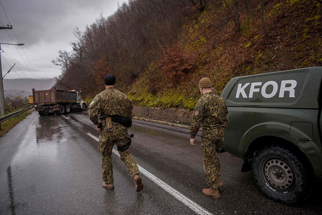 ZUBIN POTOK, Kosovo: NATO soldiers serving in the peacekeeping mission in Kosovo (KFOR) inspect a road barricade set up by ethnic Serbs near the town of Zubin Potok on December 11, 2022. Hundreds of ethnic Serbs erected barricades on a road in northern Kosovo on Saturday, blocking the traffic over the two main border crossings towards Serbia, police said. – AFP