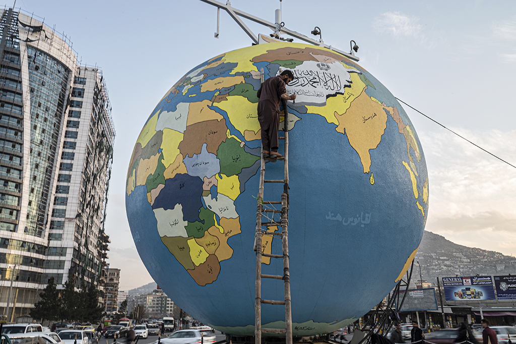 KABUL: In this photograph taken on Dec 6, 2022, a painter gives final touches to a large hand-painted globe installed by municipal authorities at the Dahan-e Bagh square. - AFP