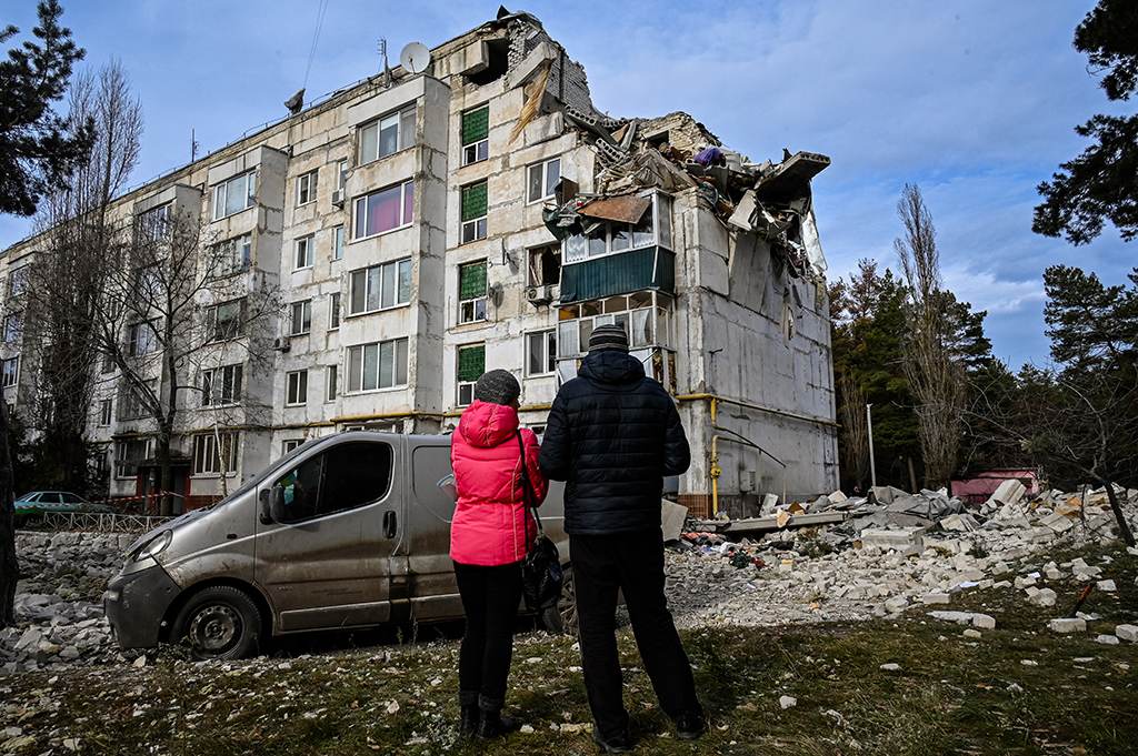 KLUHYNO-BASHKYRIVKA, Ukraine: Local residents look at a residential building damaged by a missile attack in the village of Kluhyno-Bashkyrivka, Kharkiv region, on December 2, 2022, amid the Russian invasion of Ukraine. – AFP