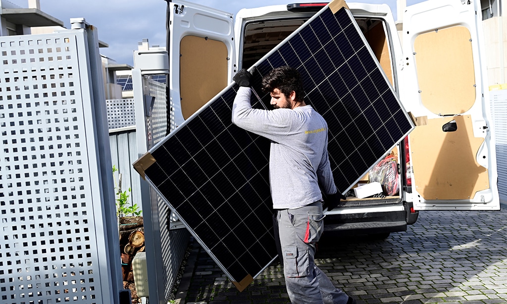 BOADILLA DEL MONTE, Spain: An employee of the company EngelSolar holds a solar panel in Boadilla del Monte near Madrid.— AFP