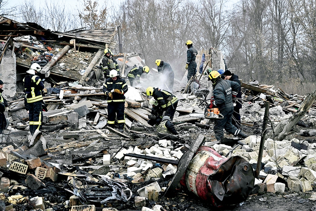 KYIV: Rescuers clear debris of homes destroyed by a missile attack on the outskirts of Kyiv on Dec 29, 2022, following a Russian missile strike on Ukraine. – AFP