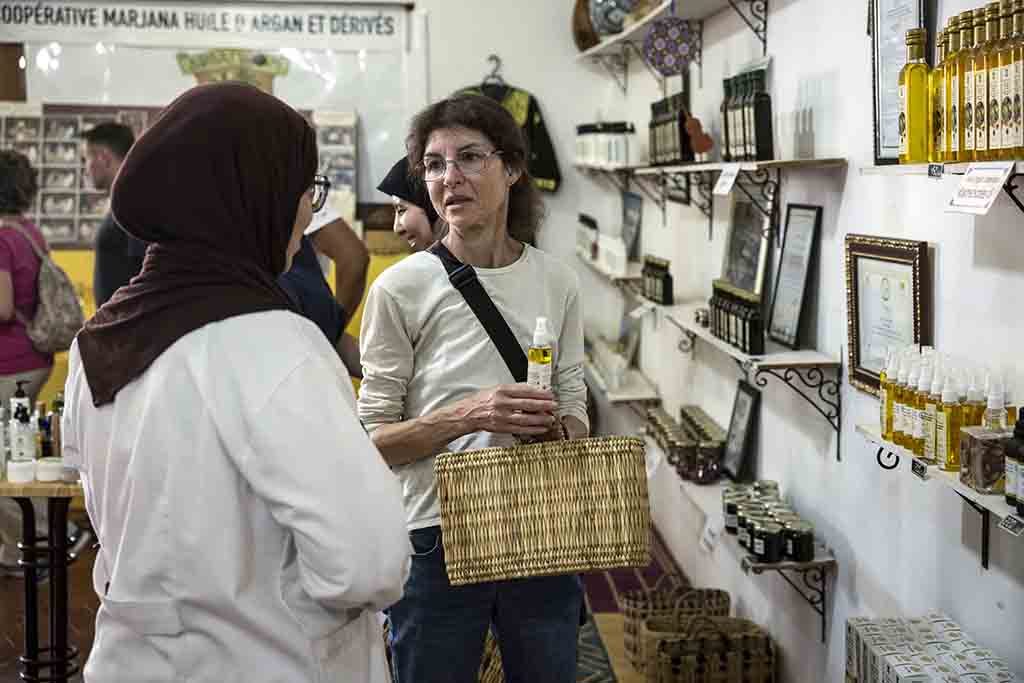 A tourist buys a bottle of argan oil at a shop near Morocco's western Atlantic coastal city of Essaouira.— AFP photos