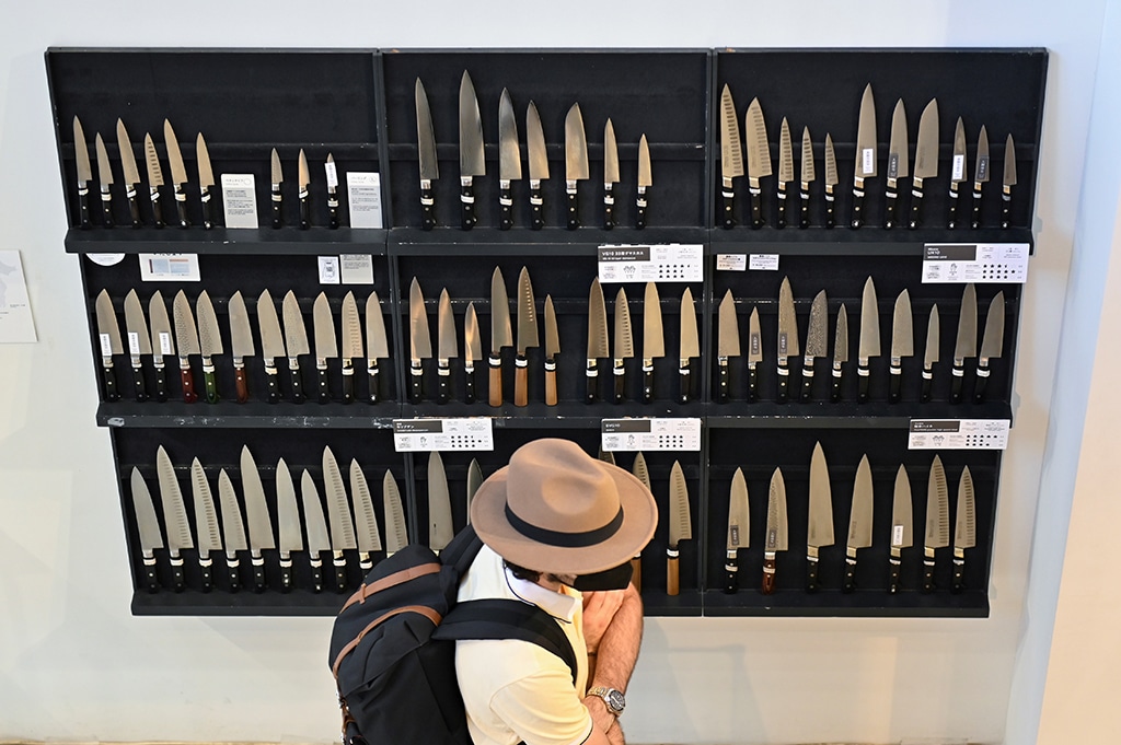 This picture shows a customer visiting Kama-Asa cutlery shop at Tokyo's famous Kappabashi kitchenware street.—AFP photos