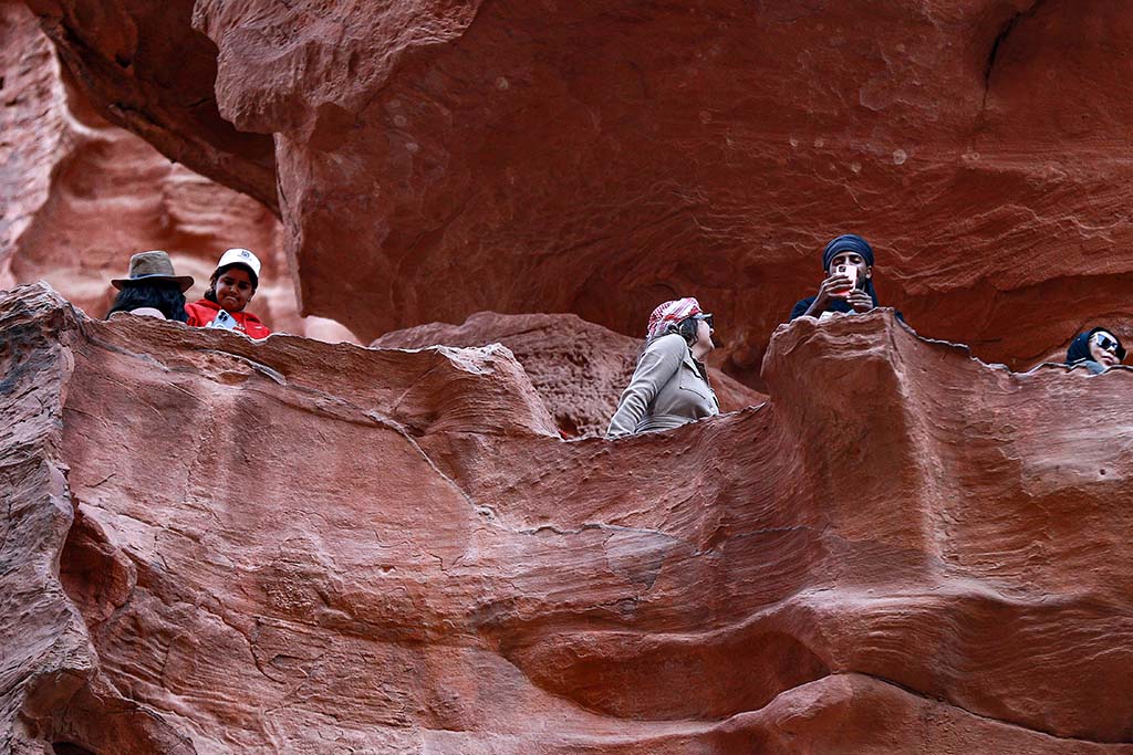 Tourists tour the ruins of the ancient Nabatean city of Petra in southern Jordan.