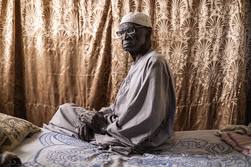Diogo Dieye 103, a former Senegalese tirailleur, who fought for the French during World War II, in Lebanon and in Libreville, poses for a portrait on his bed in Thies.-AFP photosn