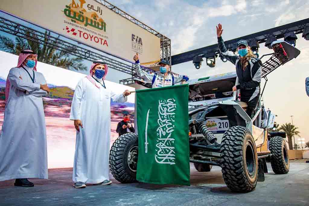 This file handout picture provided by the Sharqiyah International Baja Toyota shows Saudi rider Dania Akeel, the first ever Saudi female to tackle an international rally, waves next to her vehicle in Saudi Arabia.-AFP photos