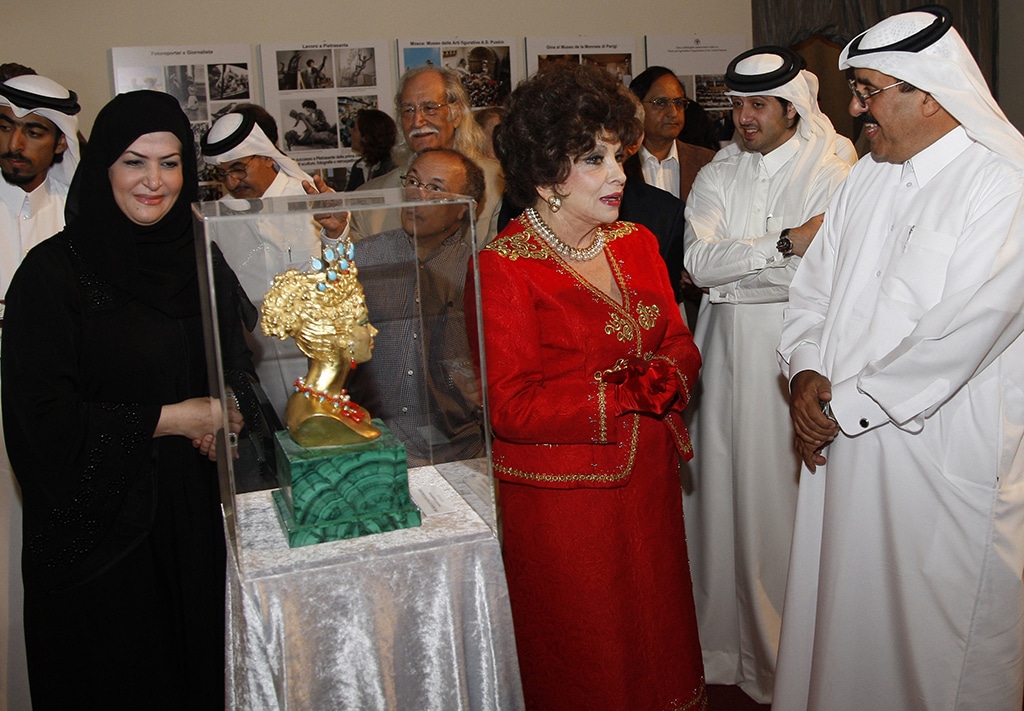 Italian actress Gina Lollobrigida (center), whose career has spanned more than six decades starting in the 1950s, attends the opening of her exhibition in the Qatari capital Doha on March 9, 2010. - AFP photos