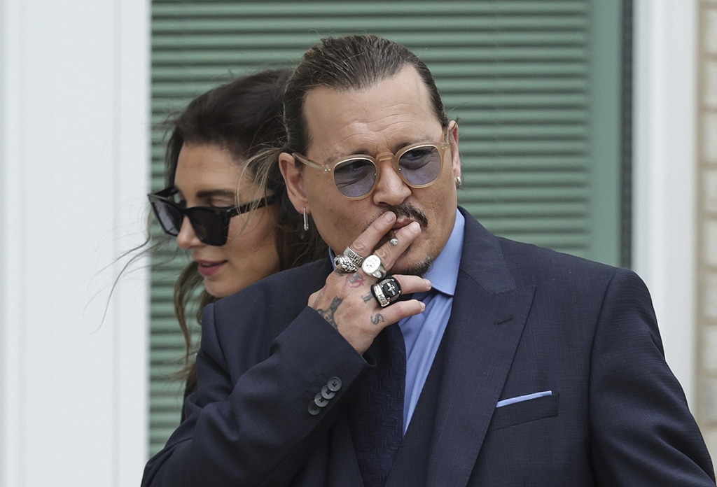 In this file photo actor Johnny Depp smokes during a break in his trial at a Fairfax County Courthouse in Fairfax, Virginia. — AFP