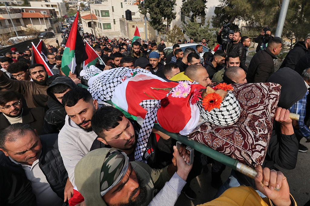 RAMMUN: Palestinians attend the funeral procession of Ahmad Kahla in the village of Rammun in the occupied West Bank, on Sunday.— AFP