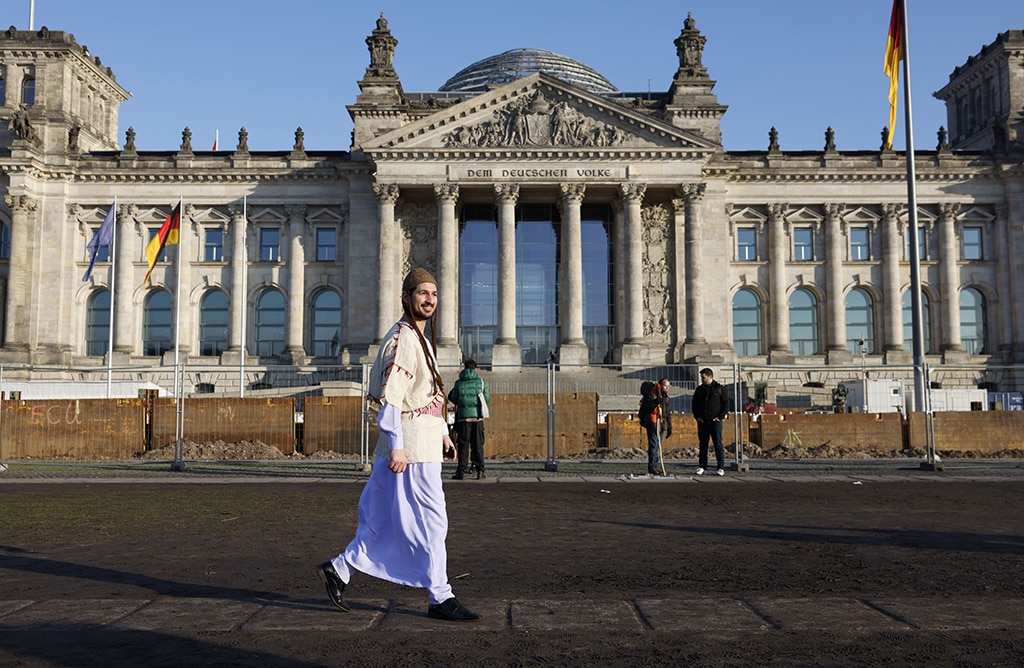 BERLIN: Atou Salo, a Yazidi refugee from Iraq who has been living in Germany for three years, walks past the Reichstag building that houses the Bundestag (lower house of parliament) in Berlin.- AFP
