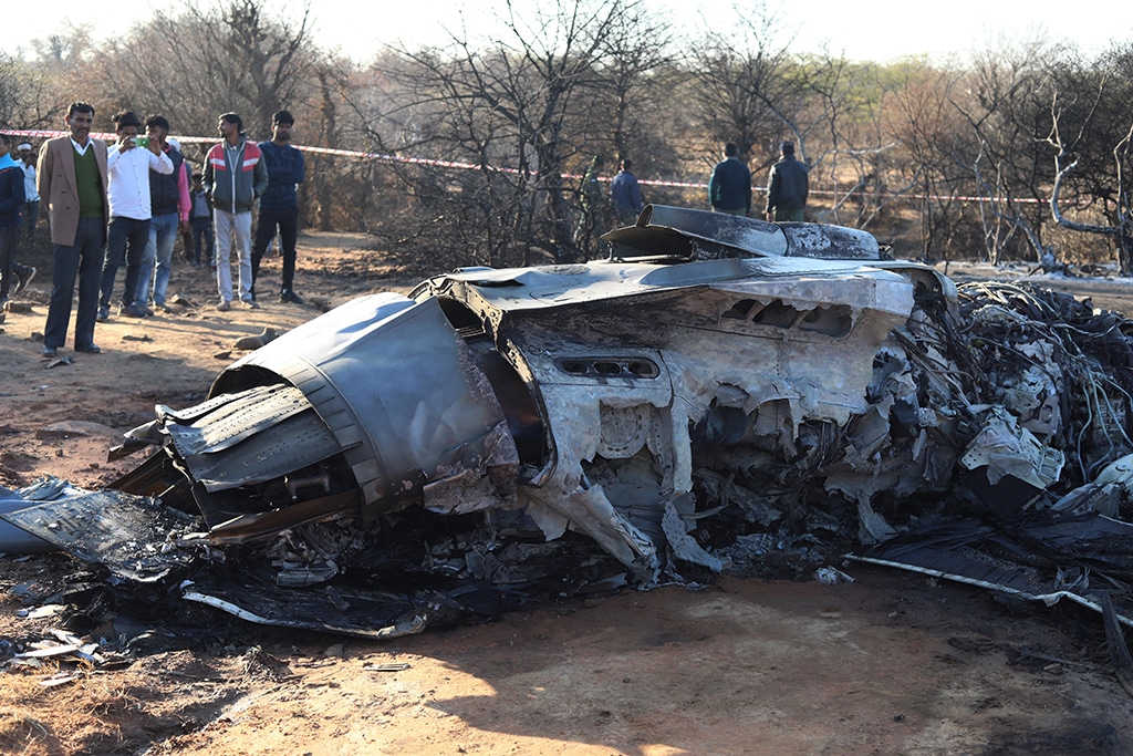 GWALIOR: People stand next to a plane wreckage after a Sukhoi Su-30 and a Dassault Mirage 2000 fighter jets crashed during an exercise in Pahadgarh area some 50 kilometers (30 miles) from Gwailor on Saturday.— AFP