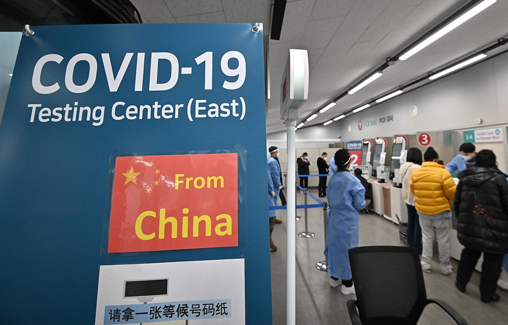 INCHEON: Health workers guide travelers arriving from CHINA at a COVID-19 testing centre at Incheon International Airport, west of Seoul. - AFP n