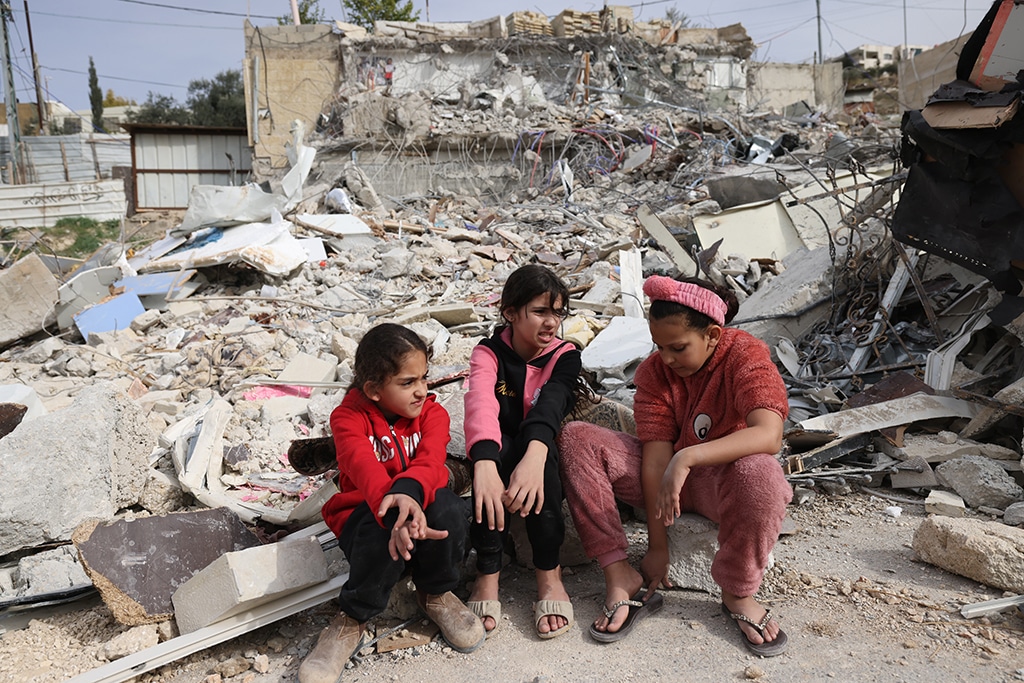 JERUSALEM: Palestinian girls sit in the debris of the house of Rateb Hatab Shukairat, after it was demolished by Israeli bulldozers, in the East Jerusalem neighborhood of Jabal Mukaber on January 29, 2023. – AFP