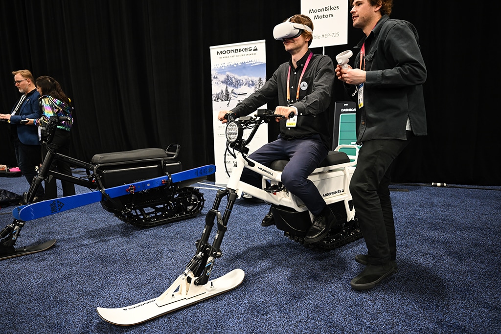 LAS VEGAS: An attendee looks through a VR headset while sitting on a Moonbikes Motors SAS electric snowbike during CES Unveiled, ahead of the Consumer Electronics Show (CES), in Las Vegas, Nevada. - AFP