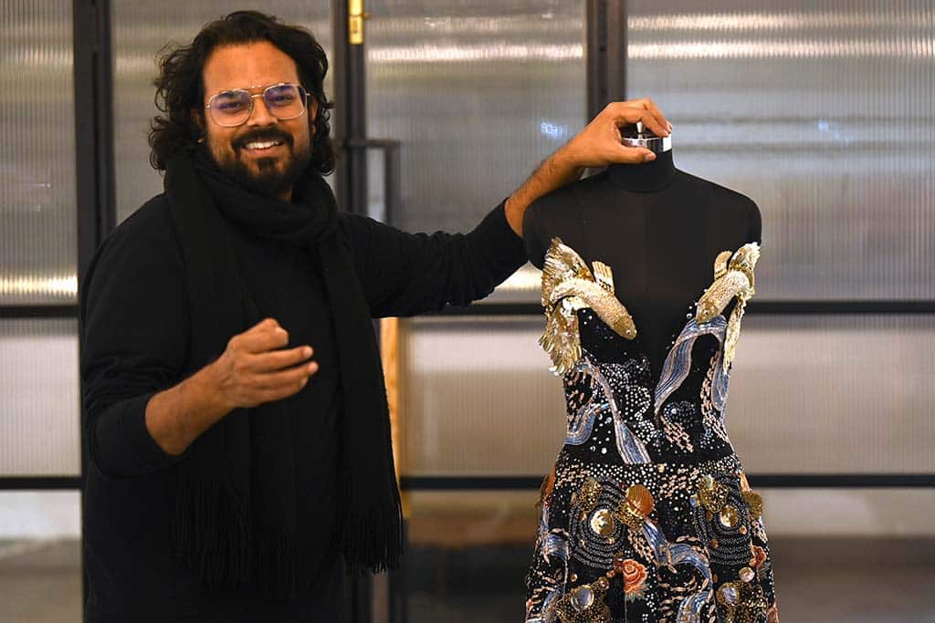 Indian fashion designer Rahul Mishra stands beside his new collection at his workshop in Noida. For a man with seemingly infinite creative ambitions, it is fitting that Indian designer Rahul Mishra's latest Paris haute couture collection attempts to encapsulate the entire universe. – AFP photos