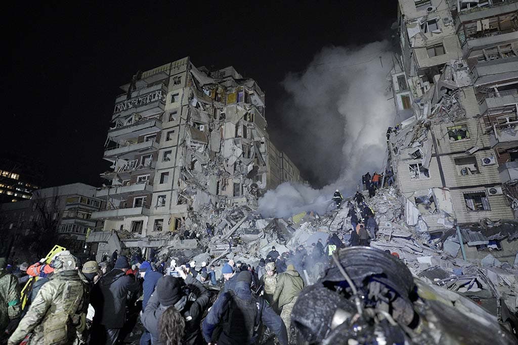 DNIPRO: Rescuers works on a residential building destroyed after a missile strike, in Dnipro. – AFP