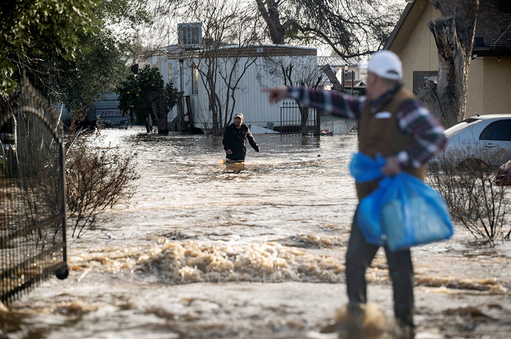 MERCED: Residents scramble to retrieve belongings before flood waters rise too high Merced, California. Relentless storms were ravaging California again, the latest bout of extreme weather that has left 18 dead. – AFP