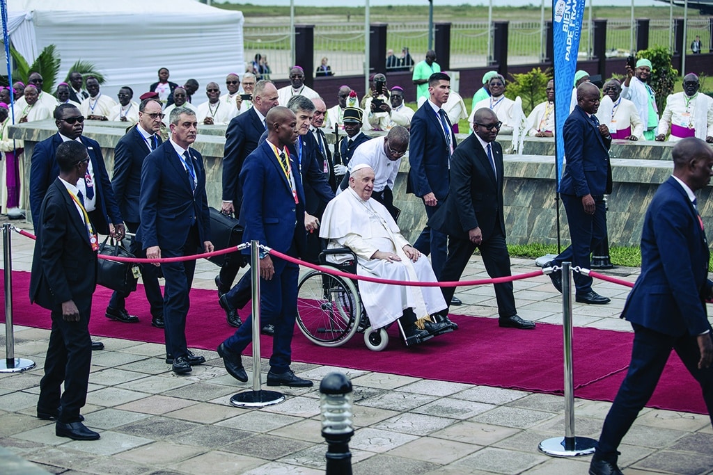 KINSHASA: Pope Francis (C), seated on a wheelchair, arrives at the N'djili International Airport in Kinshasa, Democratic Republic of Congo (DRC), on January 31, 2023. Pope Francis landed in the Democratic Republic of Congo, hailing his beautiful trip to Africa as he comes bearing a message of peace to the conflict-torn nation, before heading to troubled neighbour South Sudan. - AFP