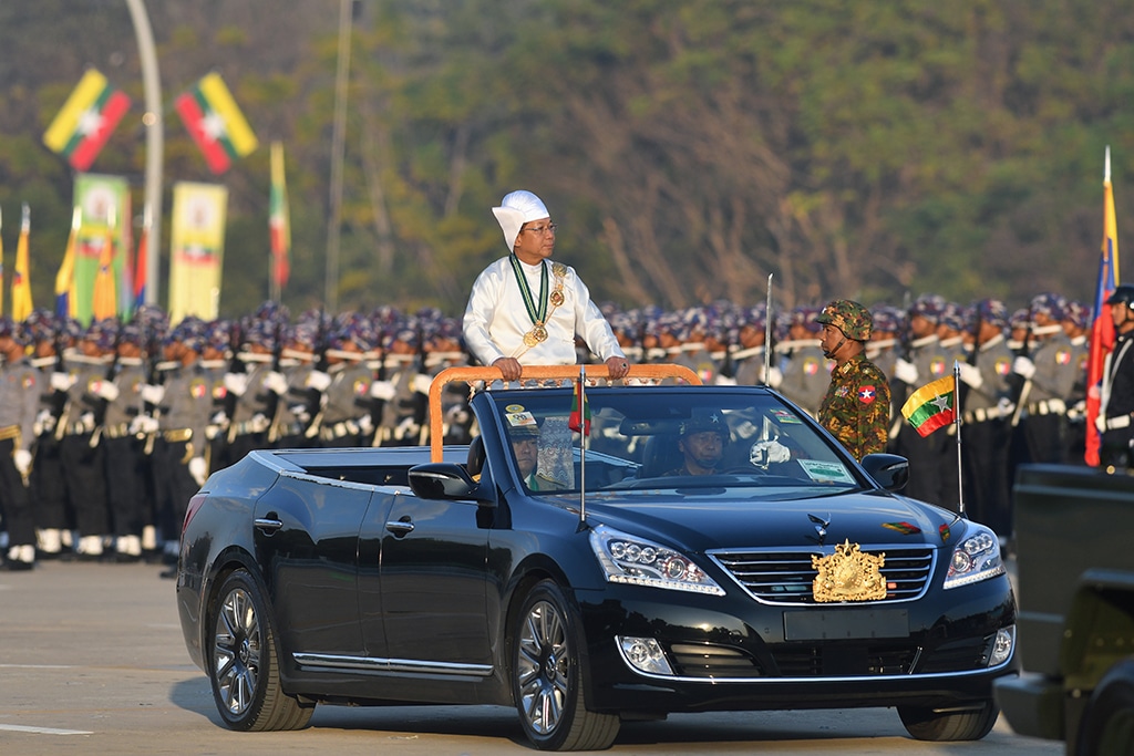 NAYPYIDAW: Myanmar's military chief Min Aung Hlaing stands in a car as he oversees a military display at a parade ground to mark the country's Independence Day in Naypyidaw on January 4, 2023. - AFP