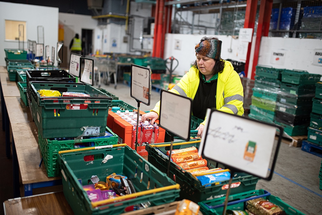 COVENTRY: A worker at The Halo Centre, the central distribution point for donated items to be distributed to the Coventry Foodbank network of 14 sites across the city, collates food items into parcels that will be provided to people with a foodbank voucher, in Coventry. – AFP