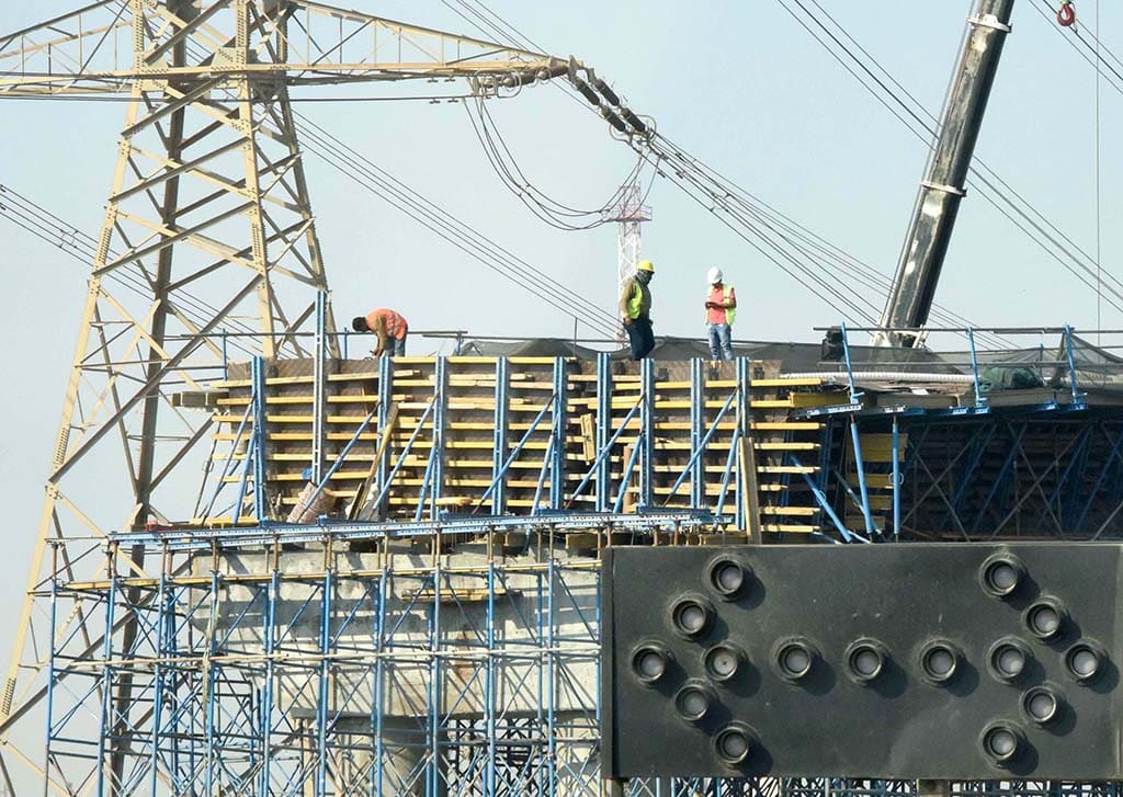KUWAIT: Construction laborers work on a bridge project.— Photo by Fouad Al-Shaikh