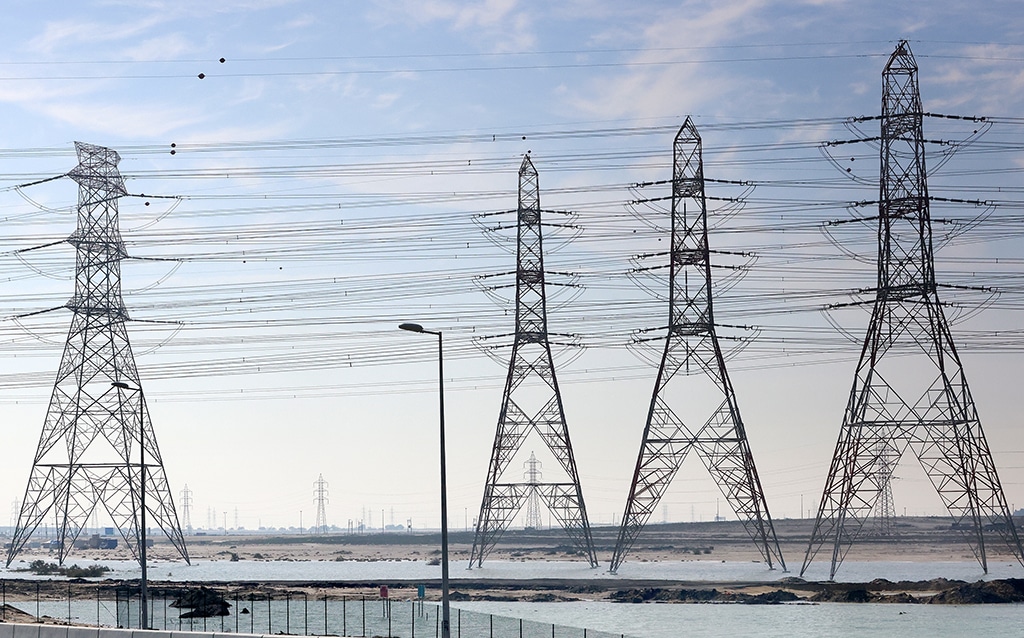 KUWAIT: Electricity pylons are seen against wisps of clouds. – Photo by Yasser Al-Zayyat