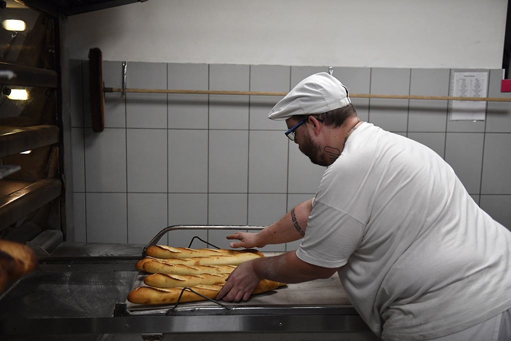 BROU, France:  In this file photo taken on December 1, 2022, a baker prepares loaves of Baguette bread in a bakery in Brou near Chartres, southwest of Paris. - AFP