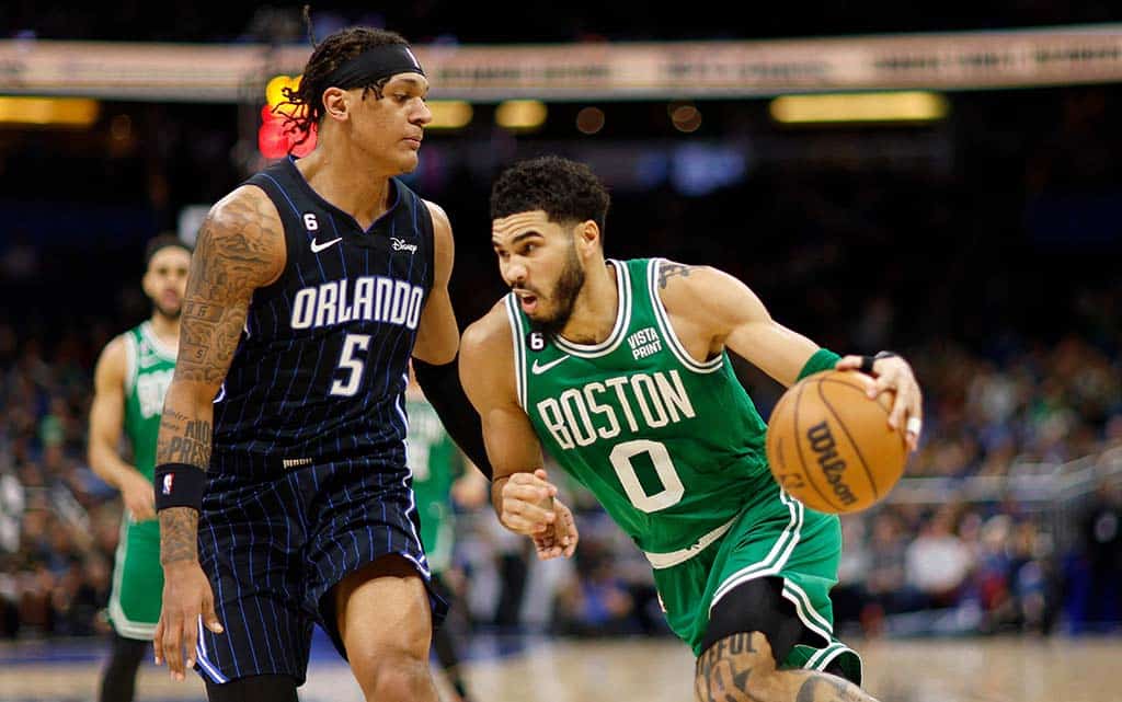 ORLANDO: Jayson Tatum of the Boston Celtics drives on Paolo Banchero of the Orlando Magic during a game at Amway Center on Jan 23, 2023. - AFP