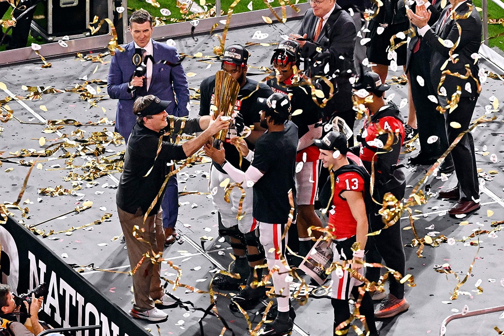 INGLEWOOD, California: Head coach Kirby Smart of the Georgia Bulldogs hands the National Championship trophy to his team after they beat the TCU Horned Frogs at SoFi Stadium on Jan 9, 2023. – AFP