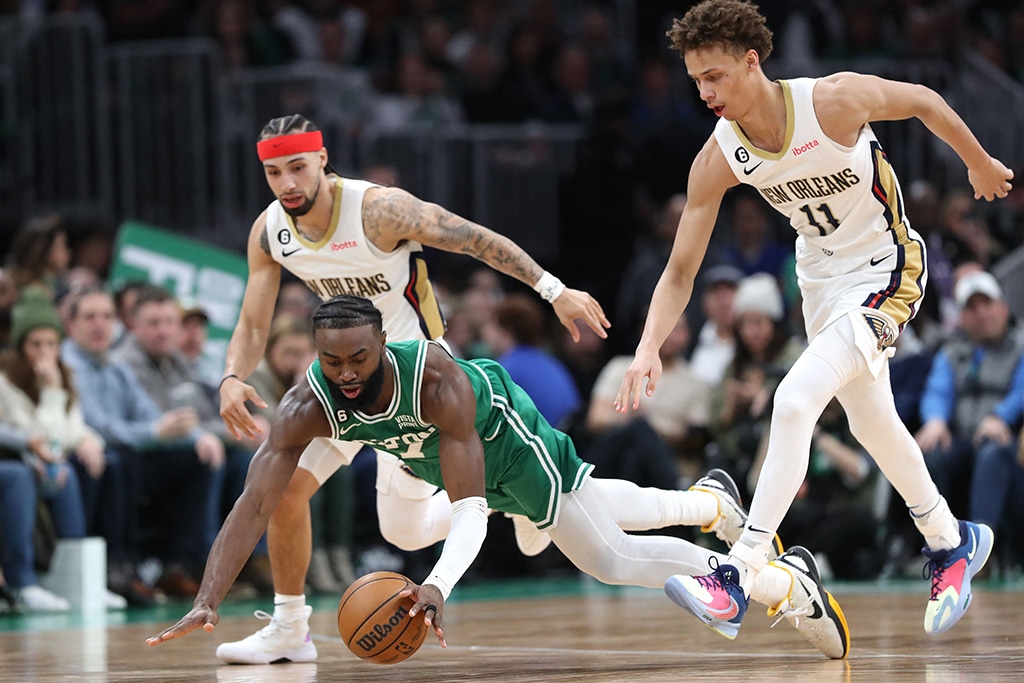 BOSTON: Jaylen Brown of the Boston Celtics dives after a loose ball in front of Dyson Daniels of the New Orleans Pelicans at TD Garden on Jan 11, 2023. – AFP