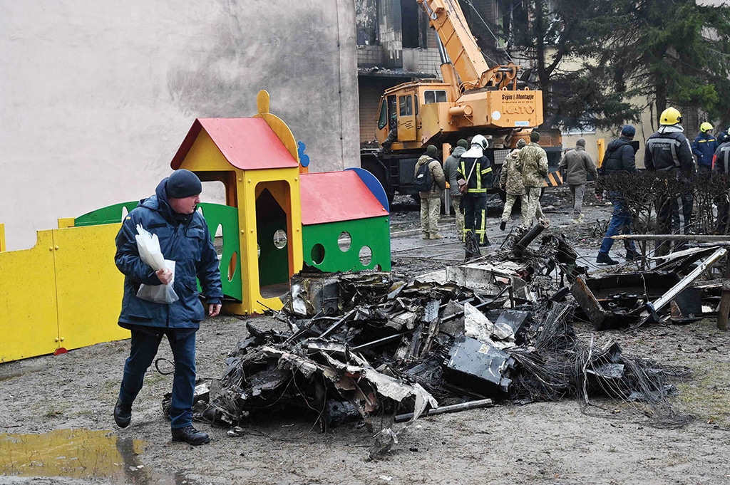 KYIV: Firefighters work near the site where a helicopter crashed near a kindergarten in Brovary on Jan 18, 2023. – AFP