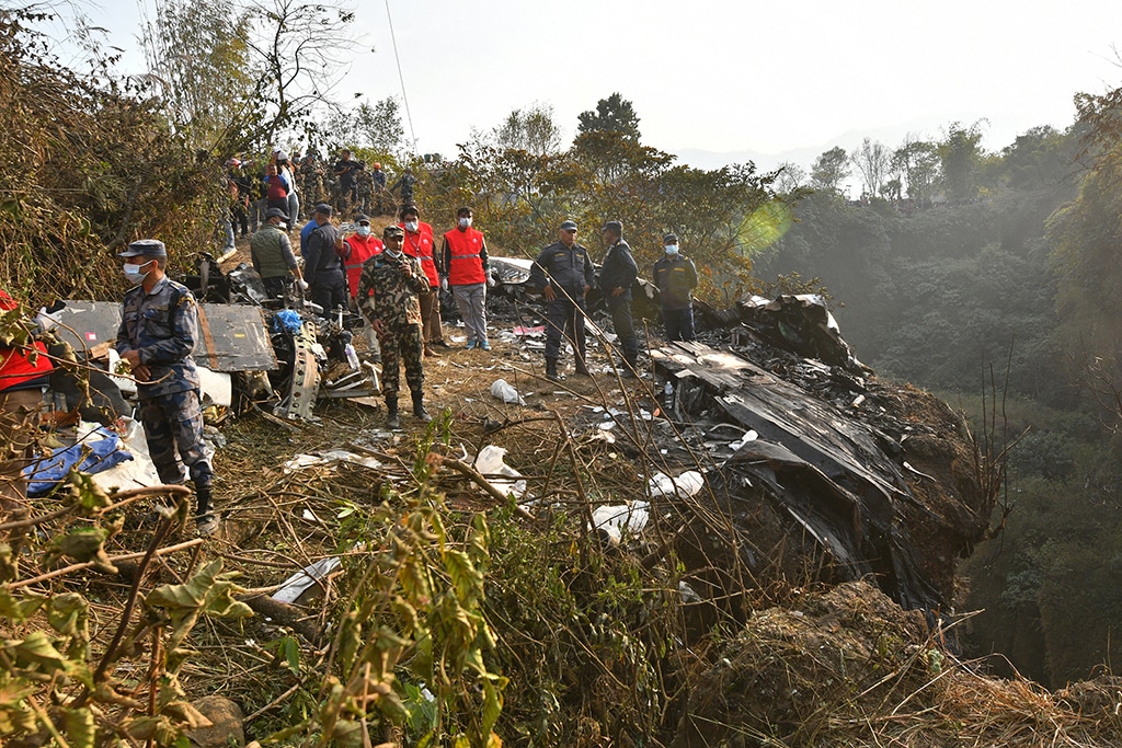 POKHARA, Nepal: Rescuers gather at the site of a plane crash in Pokhara on January 15, 2023. - AFP