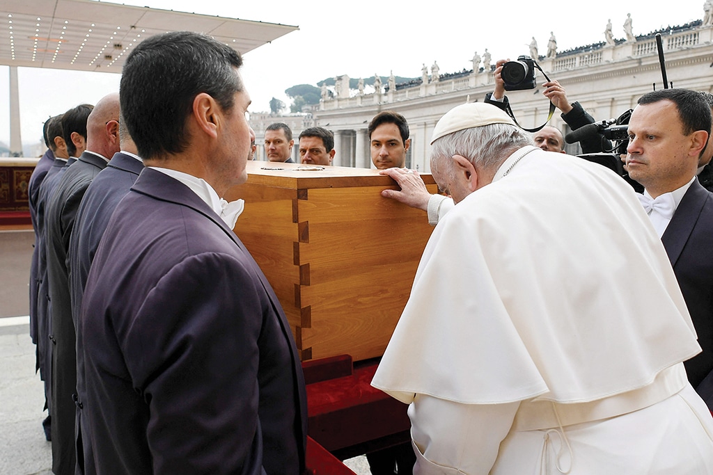 VATICAN CITY: Pope Francis pays his respects as he touches the coffin of Pope Emeritus Benedict XVI during his funeral mass at St Peter's Square on Jan 5, 2023. - AFP n