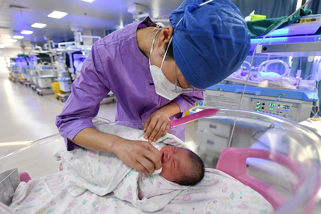 FUYANG, China: A nurse takes care of a newborn baby at a hospital in China's eastern Anhui province on Jan 17, 2023. – AFP