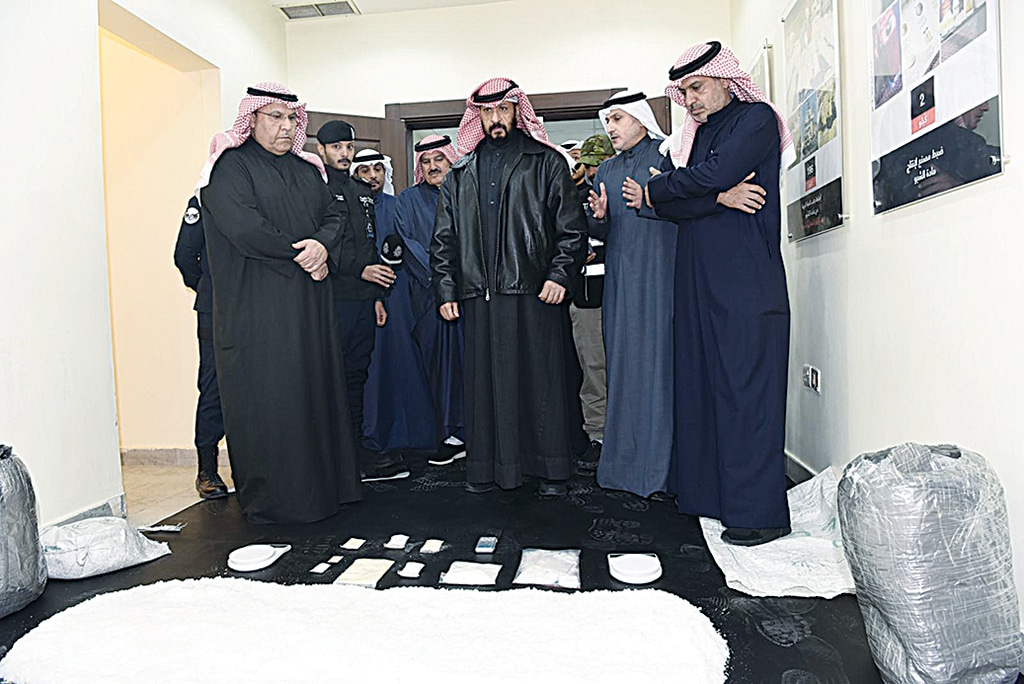 KUWAIT: First Deputy Prime Minister, Minister of Interior and Acting Minister of Defense Sheikh Talal Al-Khaled Al-Ahmad Al-Sabah supervises the inspection of the seized narcotic substances.- KUNA