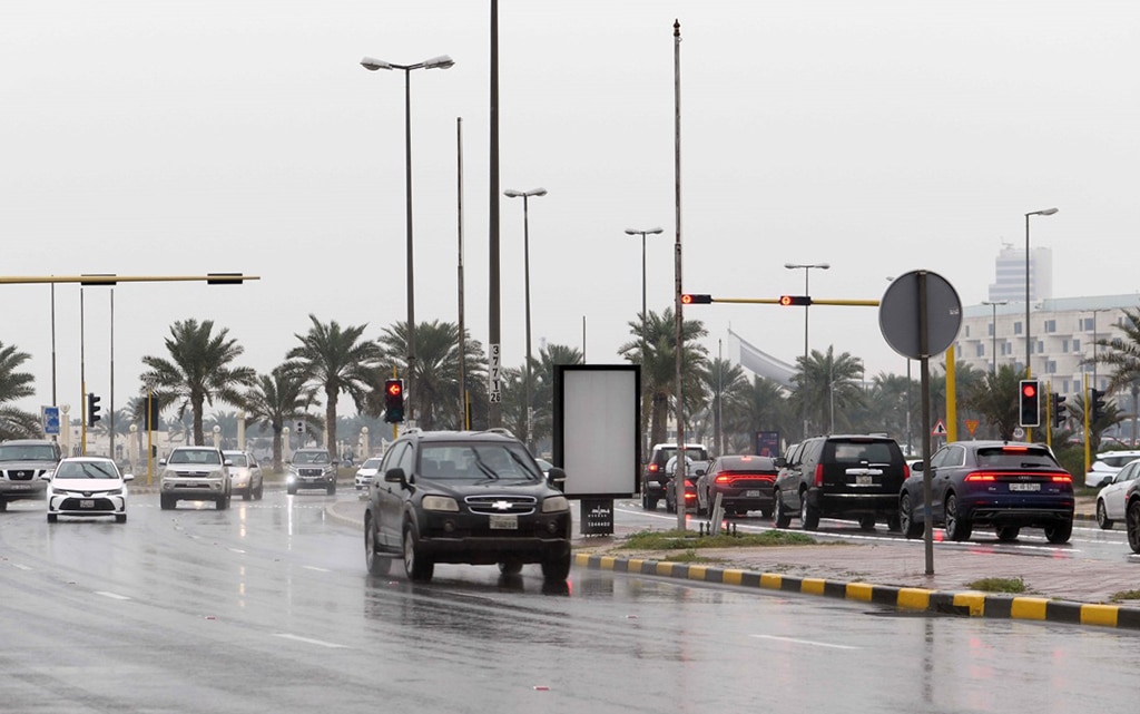 KUWAIT: Vehicles move slowly along a street as wet spell continued in Kuwait on Wednesday. -  KUNA