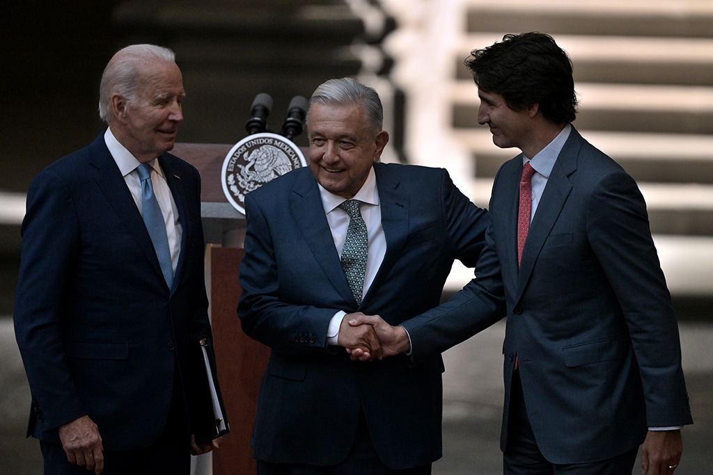 MEXICO CITY: Canadian Prime Minister Justin Trudeau (R) and Mexican President Andres Manuel Lopez Obrador (C) shake hands as US President Joe Biden looks on after speaking to the press at the end of the 10th North American Leaders’ Summit at the National Palace in Mexico City. – AFP