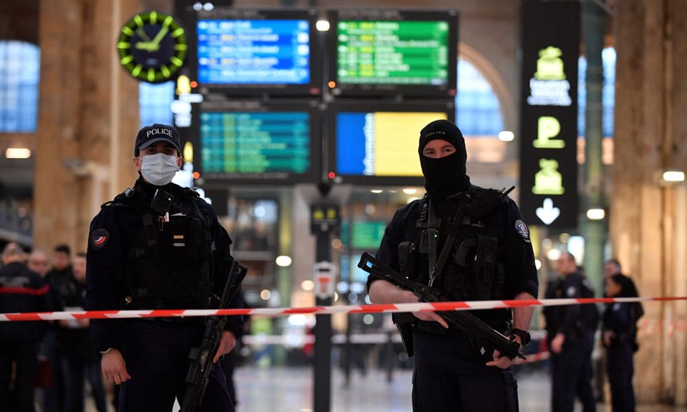 French police stand guard in a cordonned off area at Paris' Gare du Nord train station, after several people were lightly wounded by a man wielding a knife on January 11, 2023.