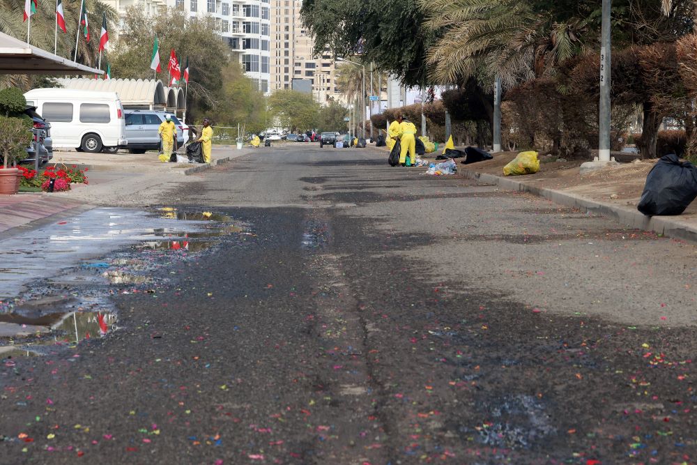 KUWAIT: Kuwait Municipality workers clean a street lettered with water balloon remains on February 27, 2023. - Photo by Yasser Al-Zayyat