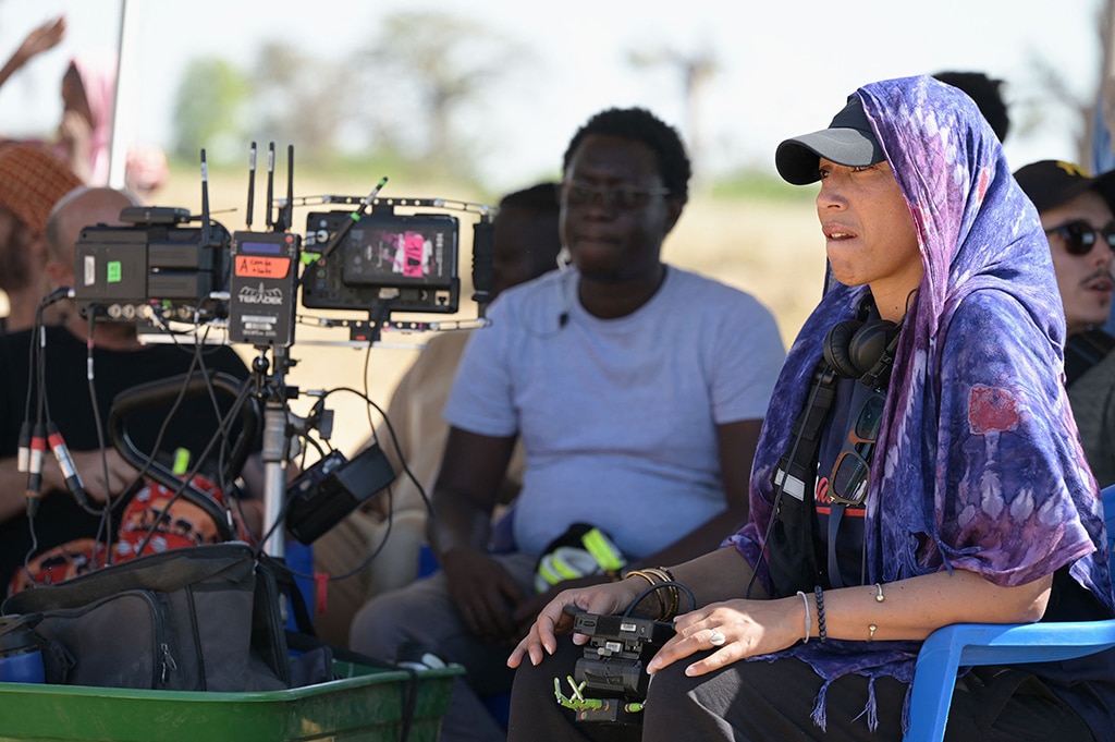 French-Senegalese director Leila Sy (right) looks oon during filming on the set of Banlieusard 2 in the forest of Bandia in Sindia, region of Thies west center of Senegal.