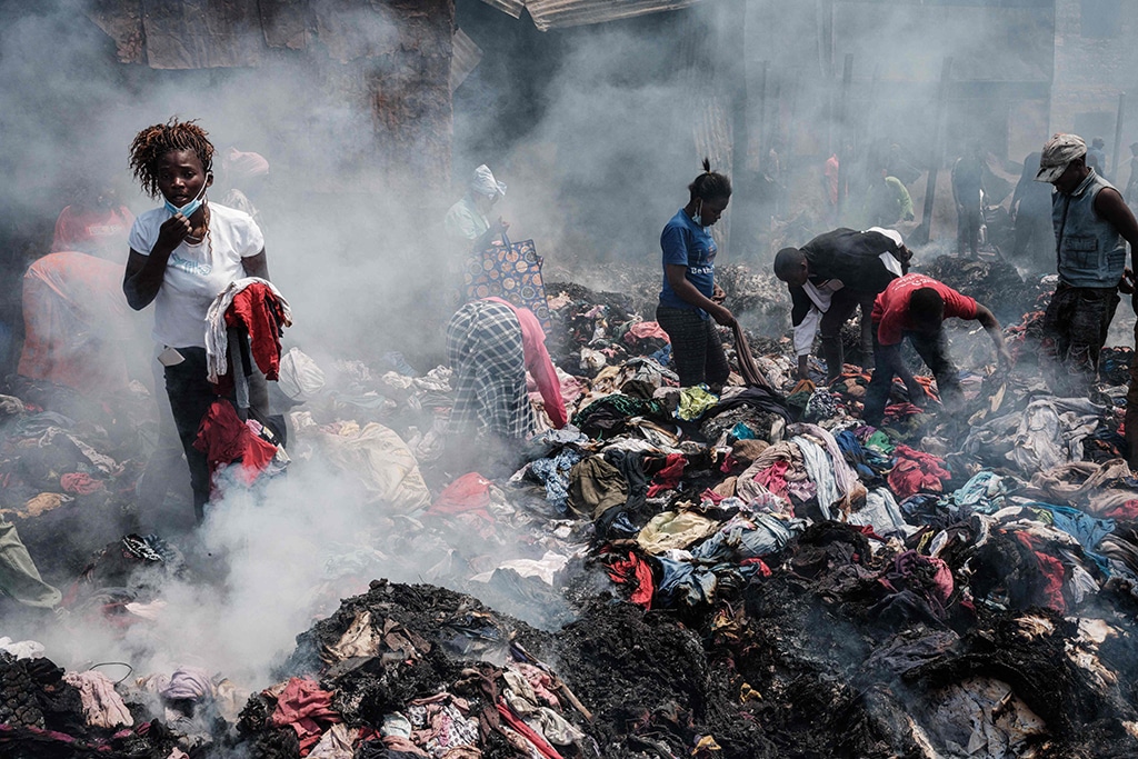 Traders scavenge clothes from debris burnt down by the fire in the early morning at Gikomba market, East Africa's largest second hand clothing market, in Nairobi, Kenya.