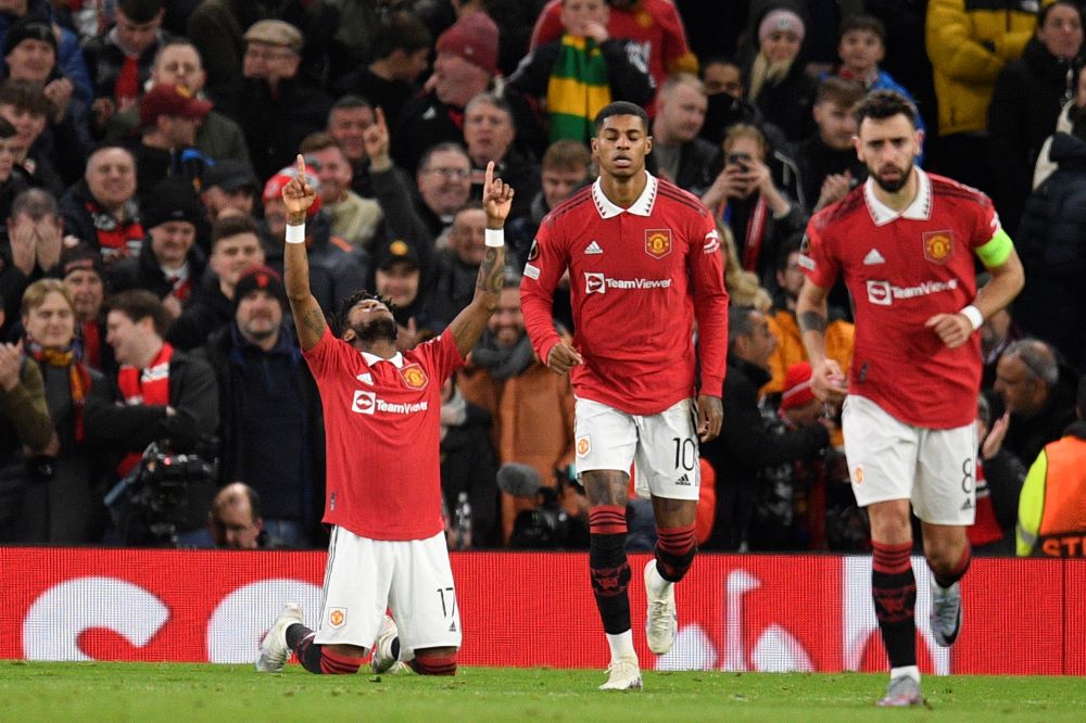Manchester: Manchester United's Brazilian midfielder Fred (L) celebrates after scoring his team first goal during the UEFA Europa league knockout round play-off second leg football match between Manchester United and FC Barcelona at Old Trafford stadium in Manchester, north west England, on February 23, 2023. - AFP