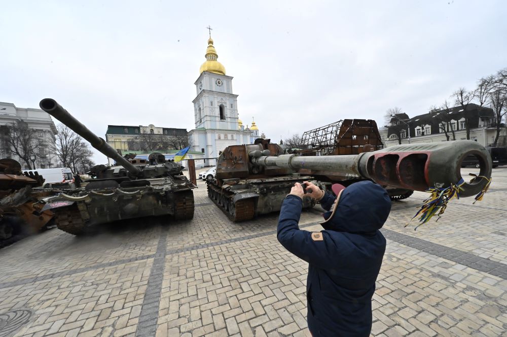 Kyiv: A man takes pictures of destroyed Russian military vehicles shown in an open air exhibition in the center of Kyiv on 24, 2023 on the first anniversary of the Russian invasion of Ukraine. - AFP