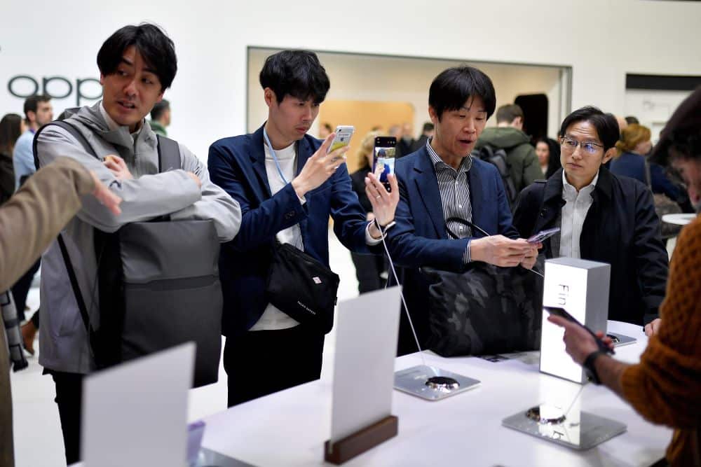 BARCELONA: Visitors look at Chinese manufacturer Oppo's Find Serie devices at the Mobile World Congress (MWC), the telecom industry's biggest annual gathering, in Barcelona on February 27, 2023.  - AFP