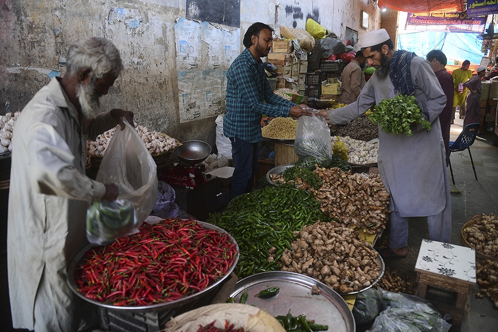 KARACHI: People buy vegetables at a market in Karachi . An IMF team left Pakistan on February 10 having failed to reach a deal on financial aid that would help the country avoid economic collapse. - AFP