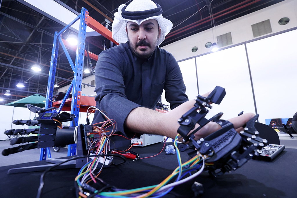 Yousef Al-Ali shows robotic arm at SWBAC booth.