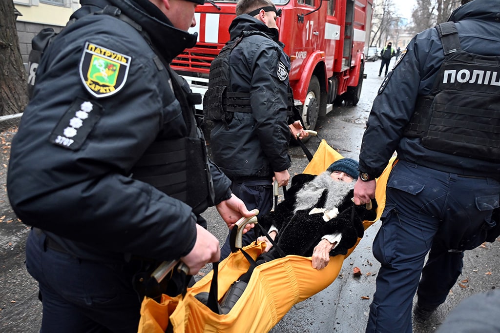 KHARKIV: Ukrainian policemen evacuate a woman wounded following a Russian missile strike in Kharkiv, on February 5, 2023. - AFP