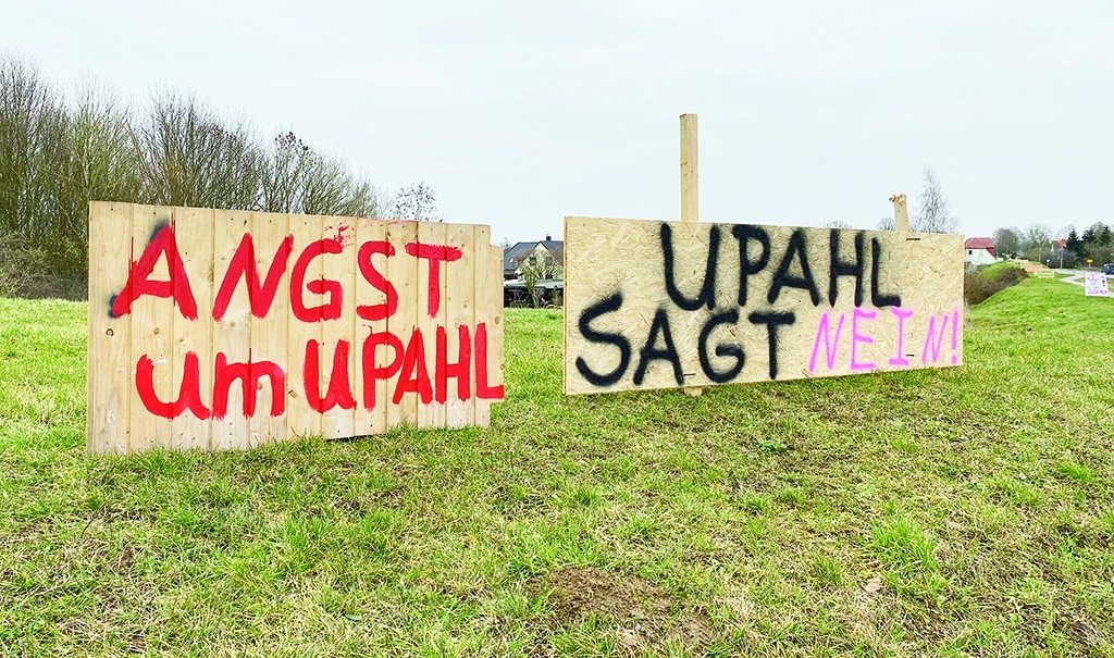 UPAHL: Placards reading 'Afraid for Upahl' (L) and 'Upahl says no' are displayed along the main road passing through Upahl, northern Germany. The main road through the northern German village of Upahl is lined with a series of wooden placards, their bright neon letters standing out against the grey sky and muddy fields. - AFP