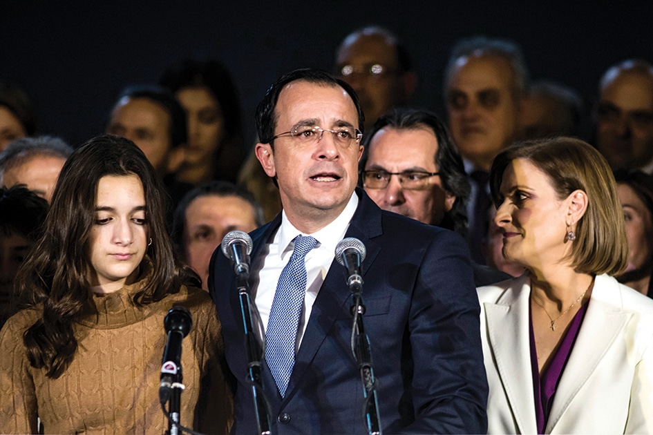NICOSIA: Cyprus' new president-elect Nikos Christodoulides speaks before supporters during a proclamation ceremony, with his wife (R) and daugther (L) standing next to him, at Eleftheria stadium in the capital Nicosia. - AFP
